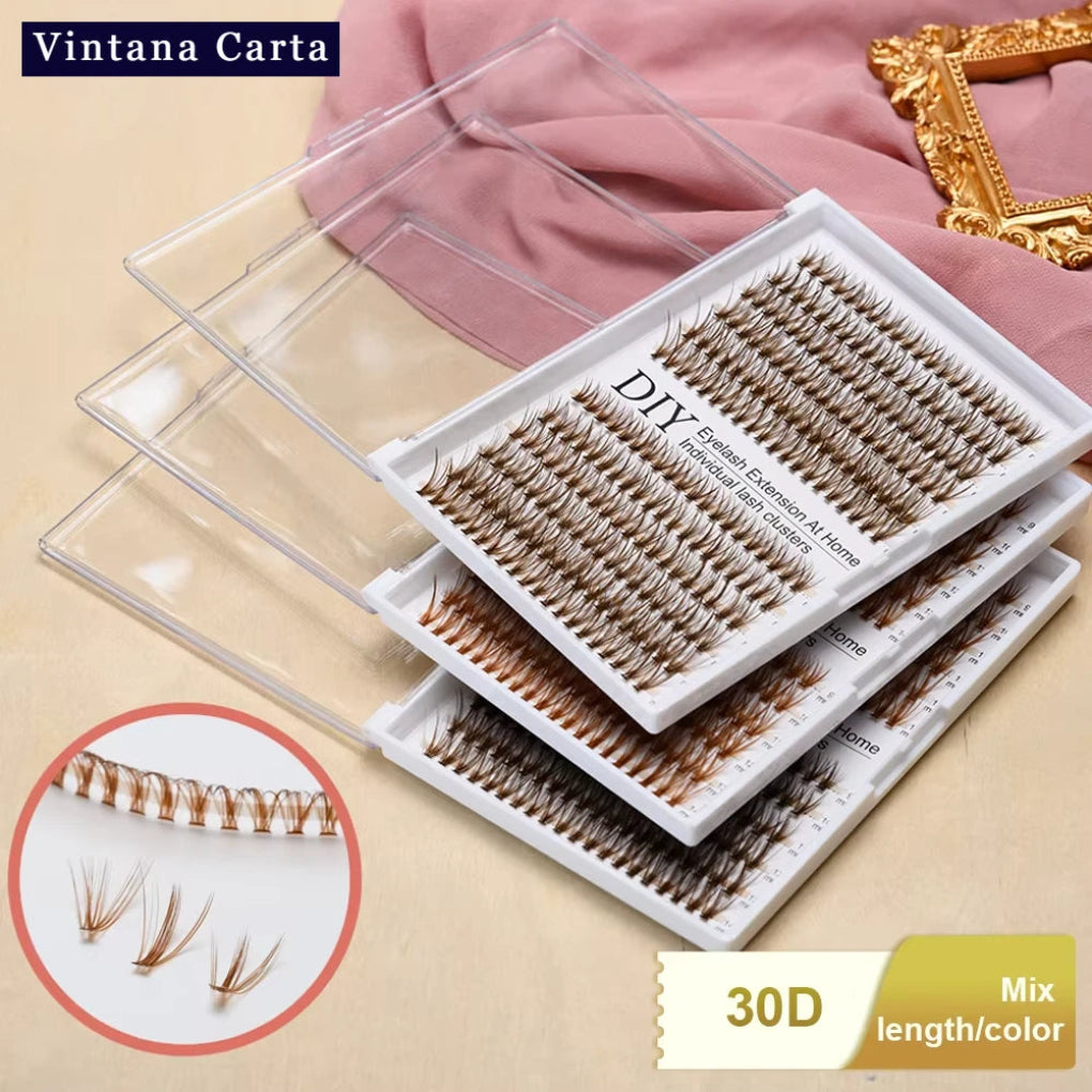 A set of individual lashes in various lengths and colors, presented in a clear plastic tray with '30D' indicating the length or technology, on a pink background.